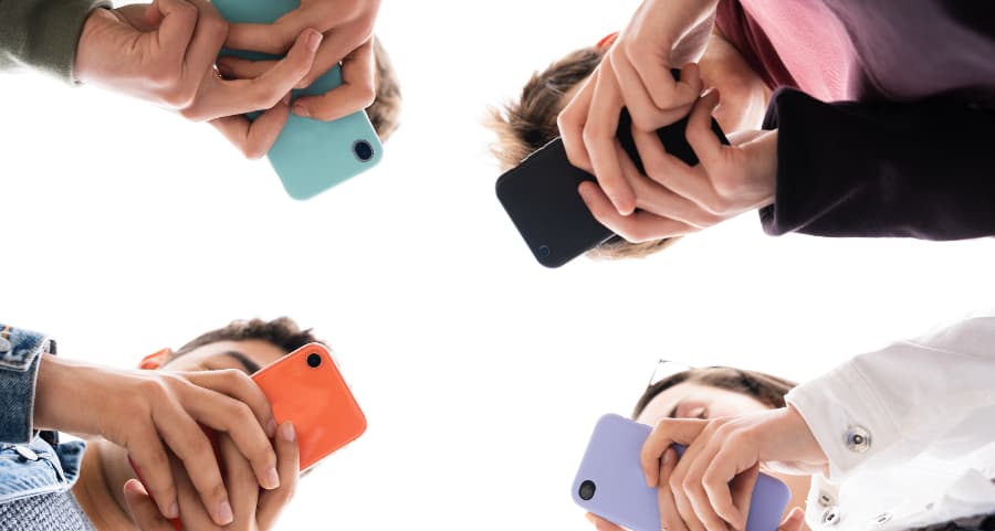 Teenagers using smartphones to access social media in Alpharetta
